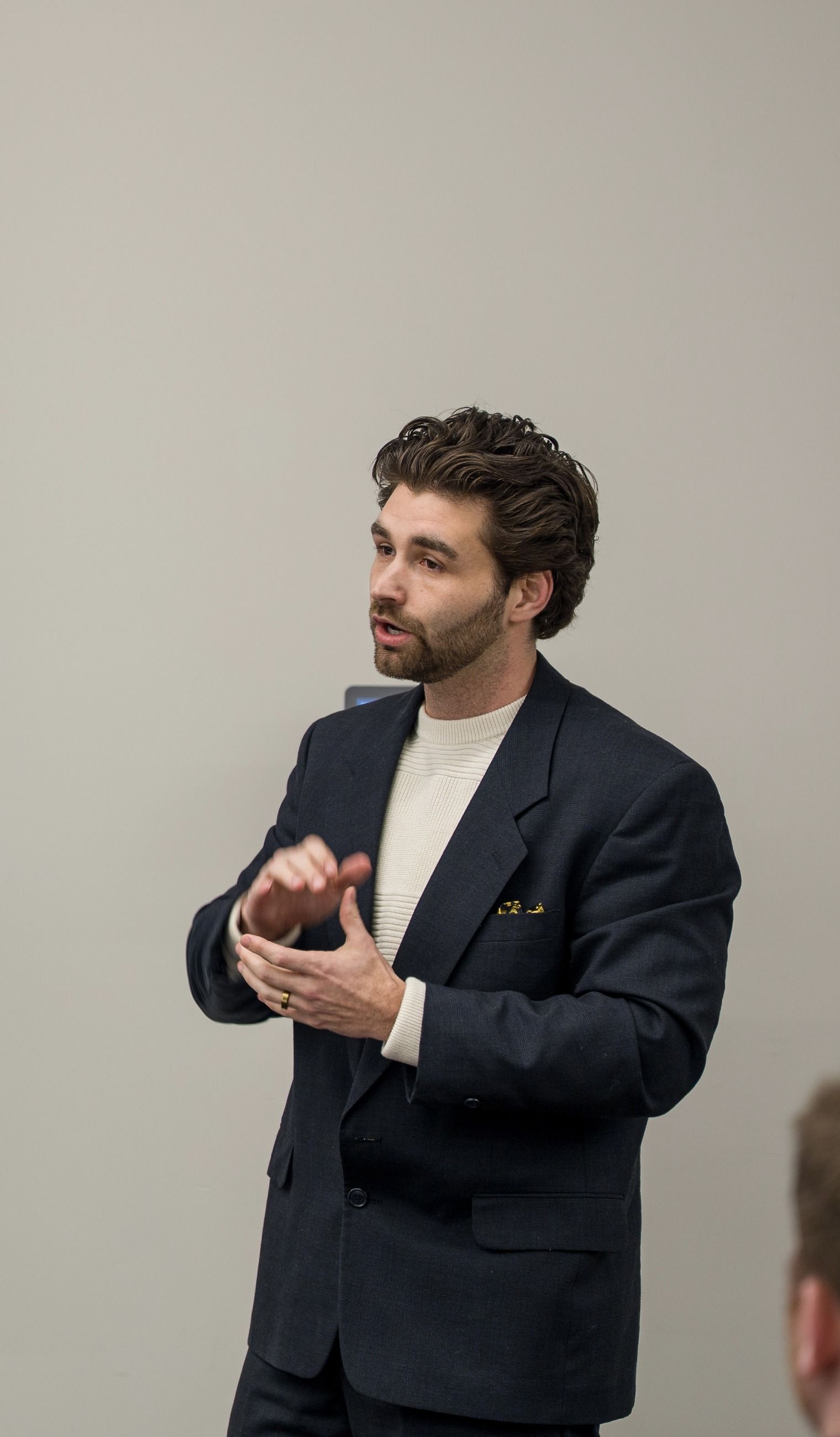 Dillon Baker explaining a point to a room
